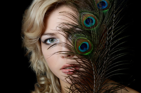The beautiful woman with feathers of peacock