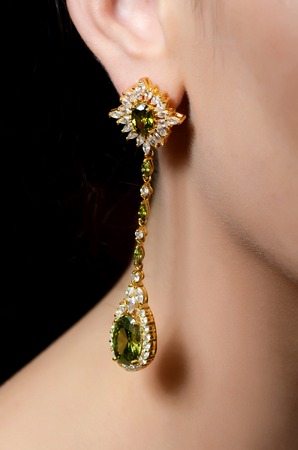 Female ear in jewelry earrings close upの写真素材