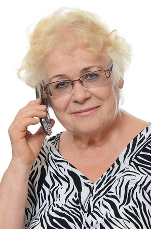 The elderly woman speaks on the phoneの写真素材