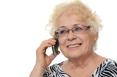 The elderly woman speaks on the phoneの写真素材
