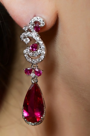 Female ear in jewelry earrings close upの写真素材