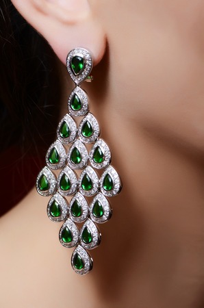 Female ear in jewelry earrings close upの写真素材