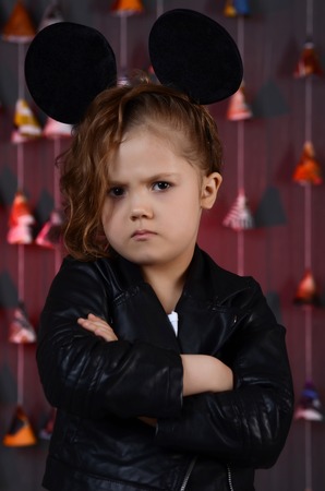 Portrait of a beautiful young female child model wearing a blackの写真素材