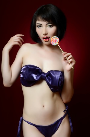 The beautiful  girl with a sugar candyの写真素材
