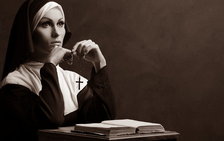 Young attractive nun prayingの写真素材