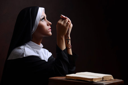 Young attractive nun prayingの写真素材
