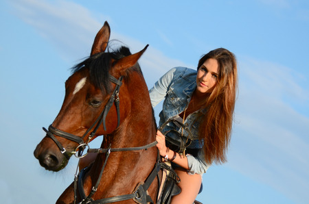 The woman on horse against the skyの写真素材