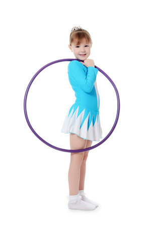 Little girl gymnast does exercise with hoopの写真素材