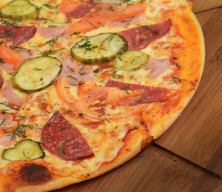 Tasty Italian pizza on wooden backgroundの写真素材