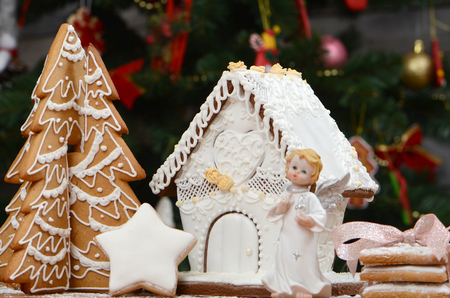 Gingerbread house, gingerbread Christmas tree, a snowman from sugar mastic - homemade sweets for children for Christmasの写真素材
