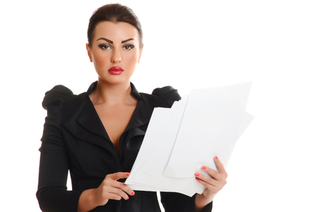 Portrait of a confident young woman standing  with documents on white backgroundの写真素材