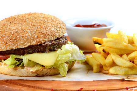 Big burger and chips on the tableの写真素材
