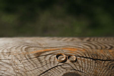 Wedding rings on a wooden background.の写真素材