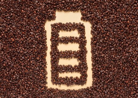Invigorating coffee in the morning provides energy for the whole day. The shape of the battery is made of coffee beans.の写真素材
