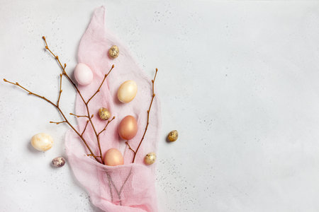 Easter composition made of gold eggs and branches