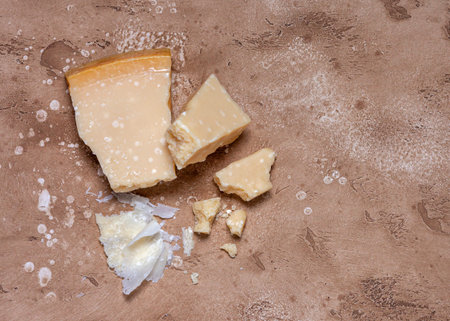 Pieces of parmesan on brown backgroundの写真素材