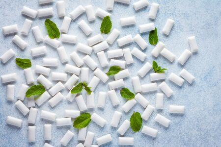 Chewing gum background. Background made of gum pads and fresh mint leaves.の写真素材