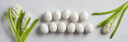 Happy easter banner. Composition made of spring flowers and eggs with the calligraphic inscription...