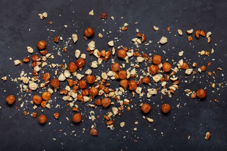 Nuts are scattered on a black background. Hazelnuts.の写真素材