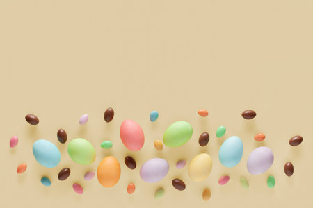 Happy Easter. Easter eggs and sweets on a yellow background. copyspace.
