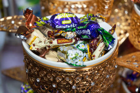 Ukraine, Vinnytsia - May 23, 2020. A variety of candies in a golden bowlのeditorial素材
