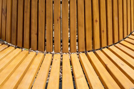 Bench with wooden boards close up. Background from wooden boards arranged in a semicircle. Wooden bench roundの写真素材