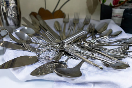 A set of various cutlery and objects. A variety of shiny metal cutlery.