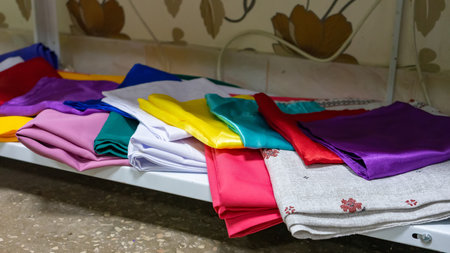 Multicolored kitchen towels lie folded on a shelf.の写真素材