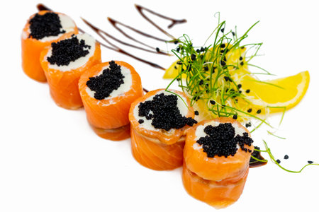 Rolls of sushi from red fish with black caviar on a white plate.の写真素材