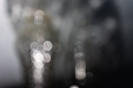 Abstract gray background formed by shadows and bokeh from the lens.