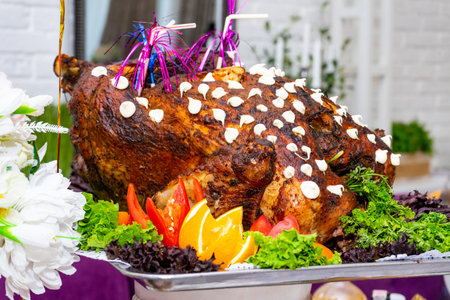 A large roast turkey on the holiday table at Thanksgiving.