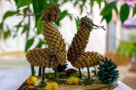 Two deers are made of cones. children's creativity. Processing of recycled materials. selective...