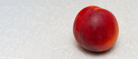 Ripe peach on textured surface.の写真素材