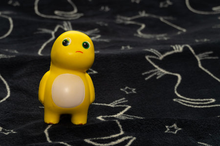 Funny yellow toy on a blue background. Antistress toy. Copy space.