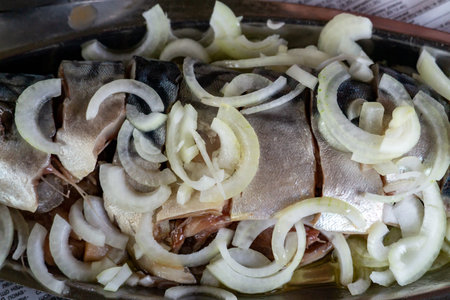Appetizing marinated herring with onions that impresses with exquisite taste