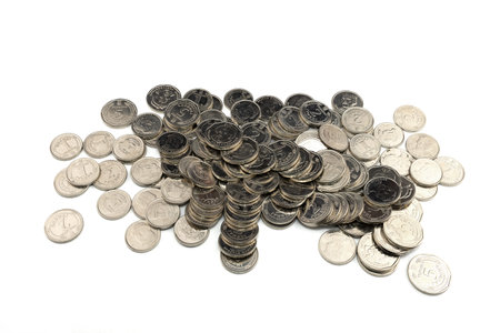 A large pile of coins rests on a clean white surface, displaying a variety of angles and...