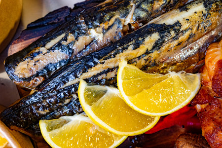 Succulent grilled mackerel garnished with vibrant lemon slices, showing a delicious seafood dish...