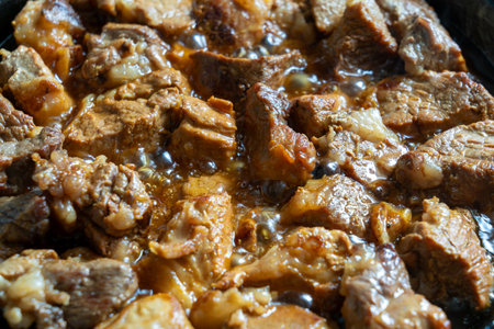 Tender pieces of pork are gently simmered in a savory sauce, showing rich flavors. The dish is perfect for sharing during a family gathering or special occasion.の写真素材