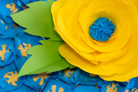 Bright yellow and blue paper flowers enhance a lively decor setup. The detailed craftsmanship showcases creativity and artistry, perfect for celebrations and events.の写真素材