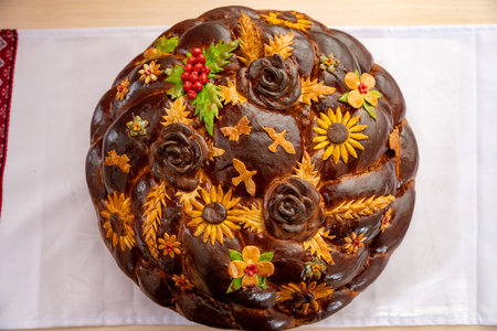 Decorative bread with floral designs displayed at a cultural event