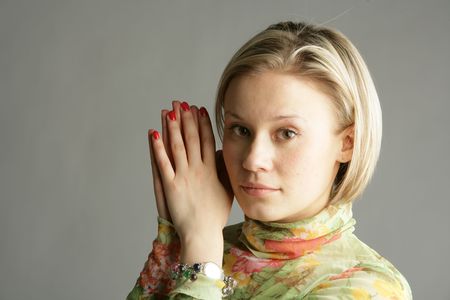 The beautiful young girl-blonde in a light green blouse の写真素材
