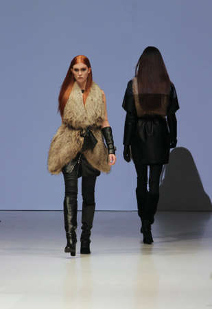 TORONTO - MARCH 15: Models pass each other on the runway in the Rudsak runway show for the Fall/Winter 2012 season at Toronto's World Mastercard Fashion Week on March 15th 2012.のeditorial素材