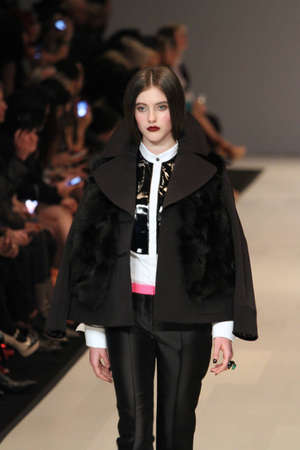 TORONTO - MARCH 15: A model walks the runway in the Pink Tartan runway show for the Fall/Winter 2012 season at Toronto's World Mastercard Fashion Week on March 15th 2012.のeditorial素材