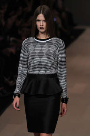 TORONTO - MARCH 15: A model walks the runway in the Pink Tartan runway show for the Fall/Winter 2012 season at Toronto's World Mastercard Fashion Week on March 15th 2012.のeditorial素材