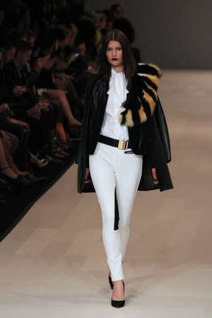 TORONTO - MARCH 15: A model walks the runway in the Pink Tartan runway show for the Fall/Winter 2012 season at Toronto's World Mastercard Fashion Week on March 15th 2012.のeditorial素材