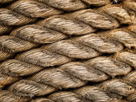 Old weathered rope worn down to expose individual strands