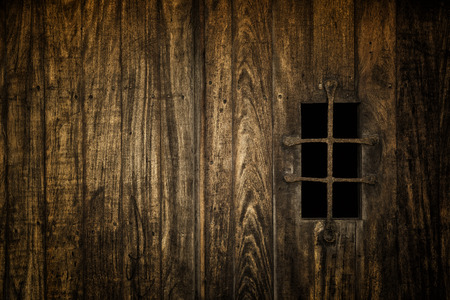 Historic medieval window secured with iron barsの写真素材