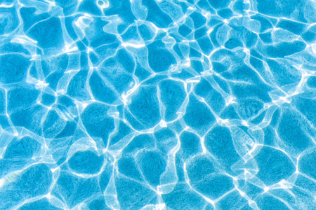 water patterns of blue and white as the midday sun reflects of pool water.