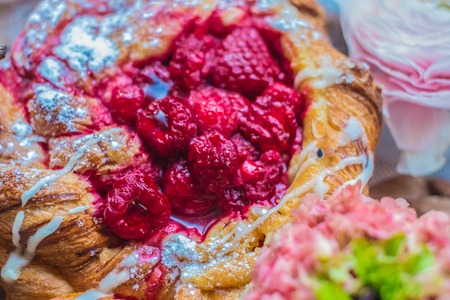 Fresh delicious buns with raspberry jam for the breakfast with  a rose on vintage plateの写真素材