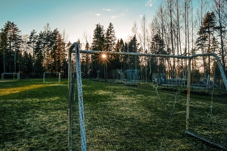 Abandoned frozen soccer field in sunsetの写真素材